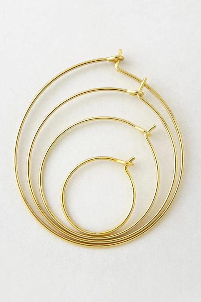 showing all four sizes of thin gold hoops, showing the difference in size between each option