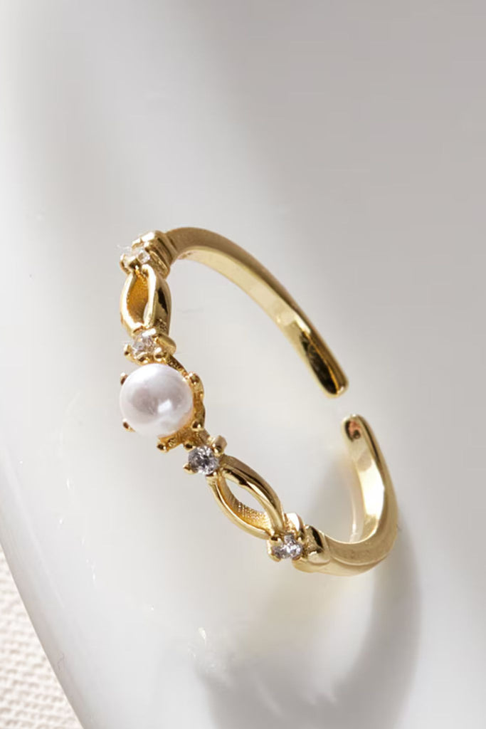 close up of the pearl and cz details on the gold plated open ring
