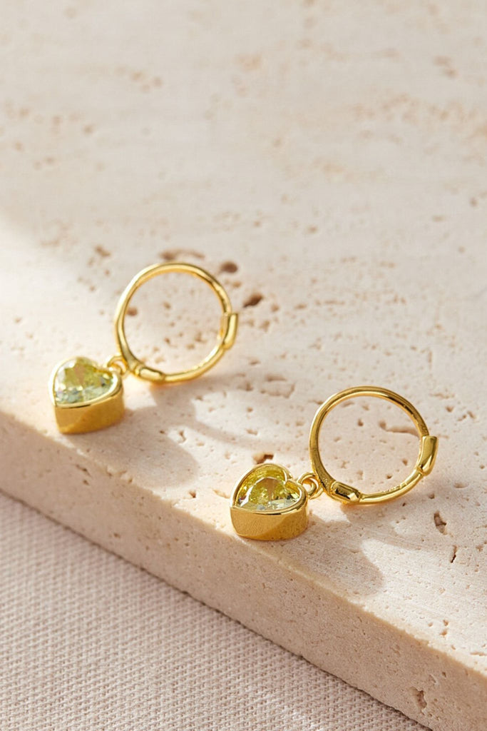 close up of the august birthstone earring, light yellow birthstone heart