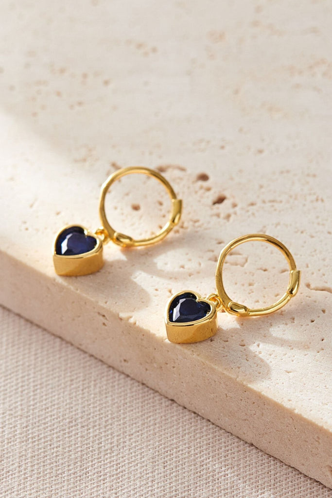 close up of the september birthstone option, dark blue cz earrings