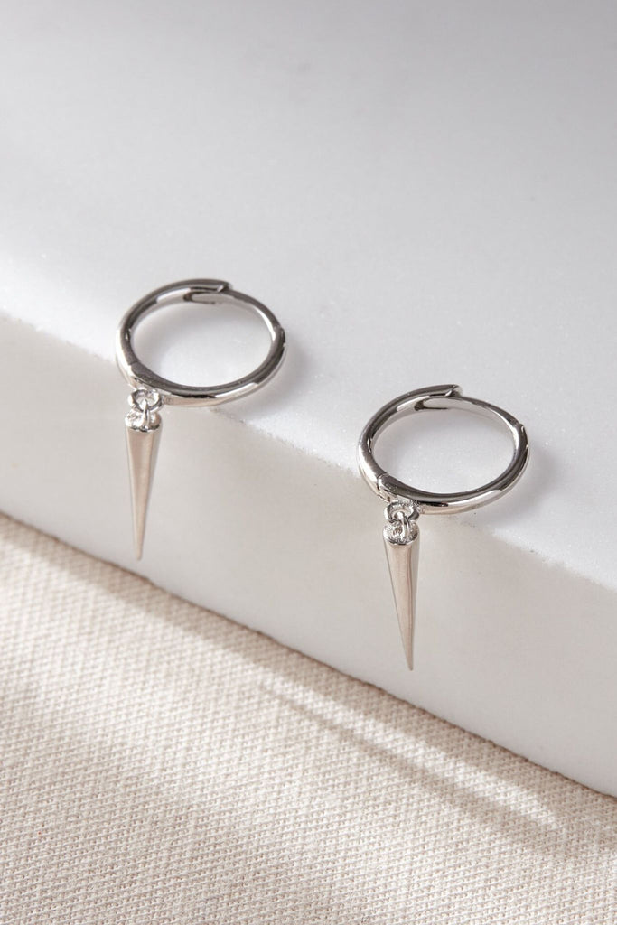 close up of the silver spike drop hoop earrings