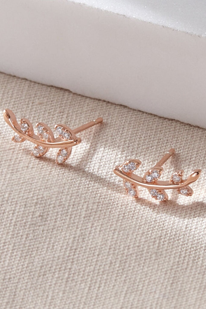 close up of the rose gold plated silver and white cz leaf stud earrings