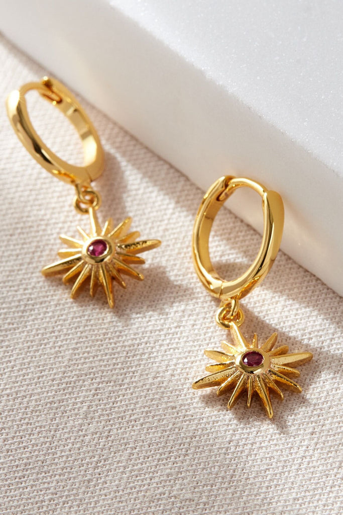 close up of the gold and red cz crystal north star dangle hoop earrings