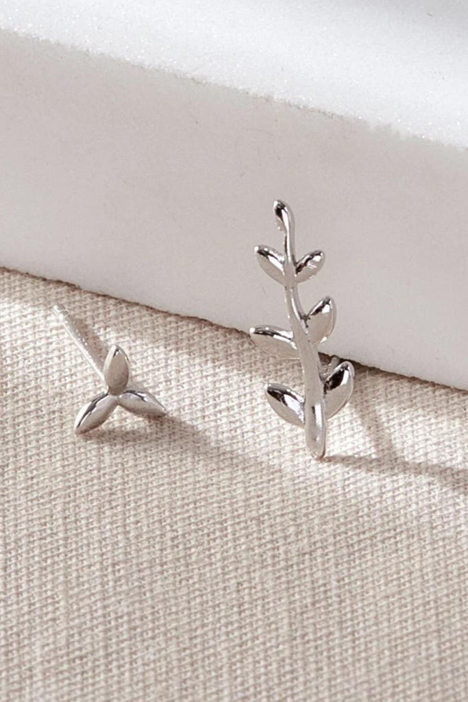 close up of the asymmetrical silver leaf stud earrings