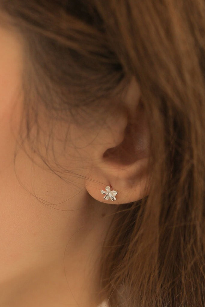 model showing the cherry blossom stud being worn on the earlobe