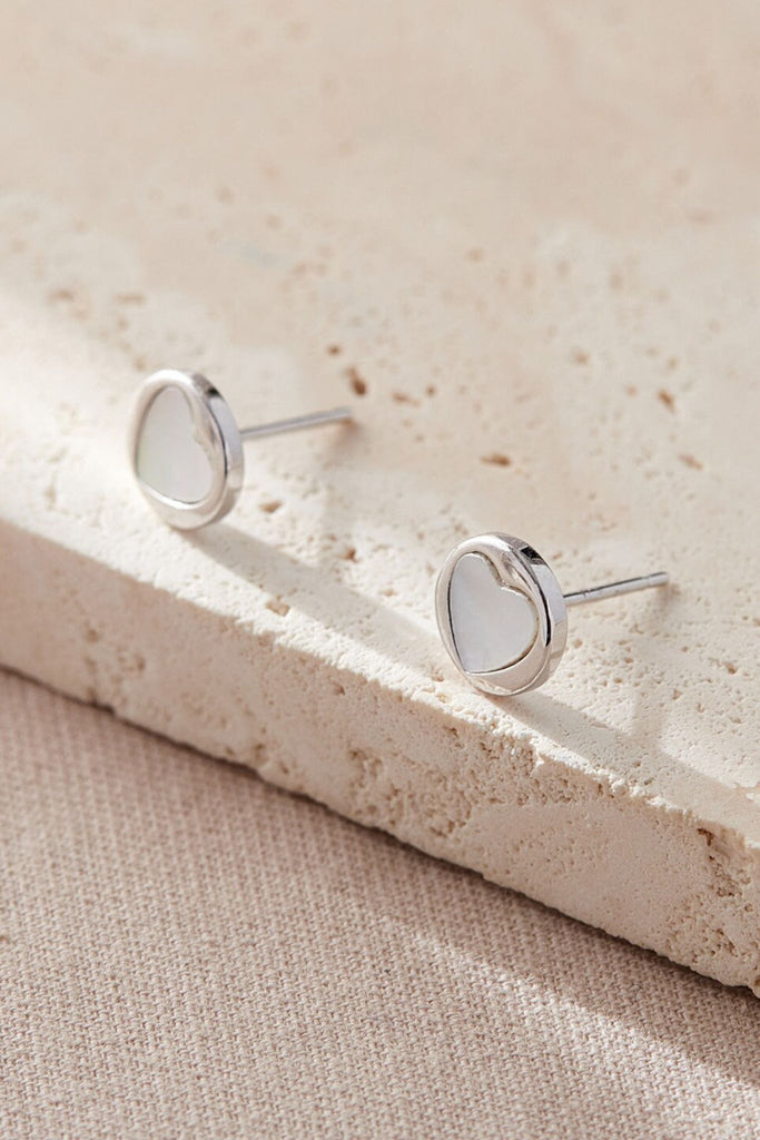 close up of the silver and mother of pearl heart stud earrings