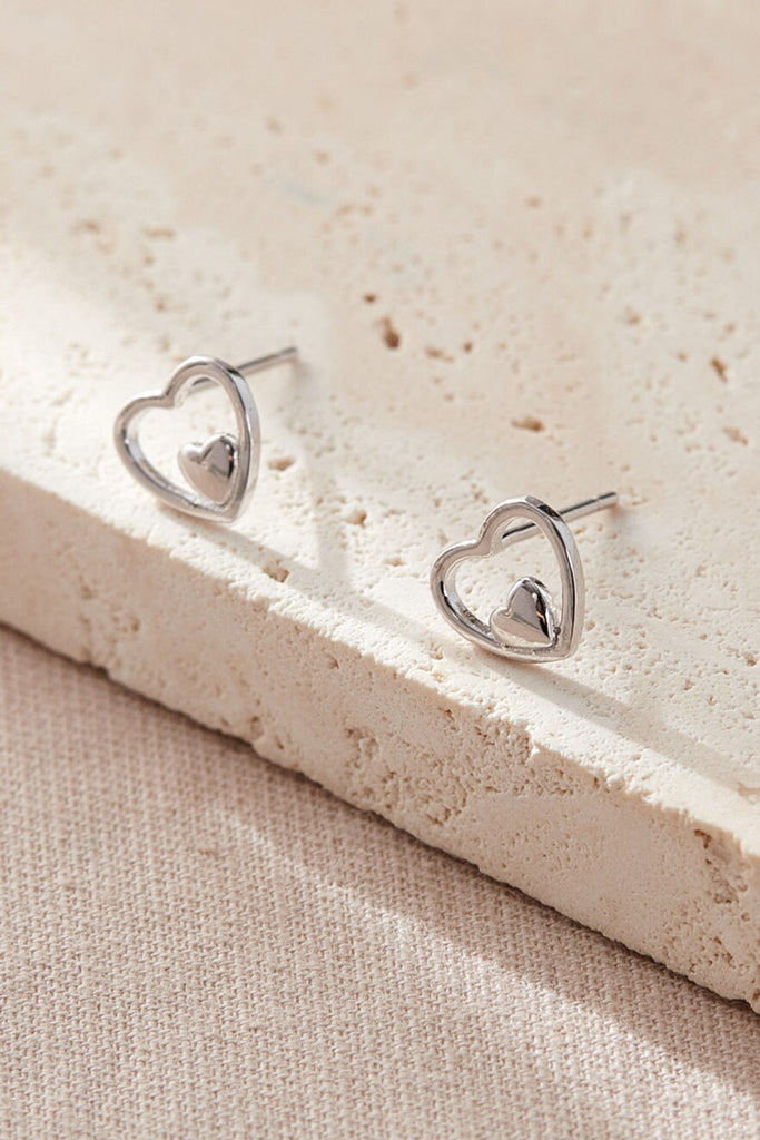 close up of the silver openwork heart stud earrings