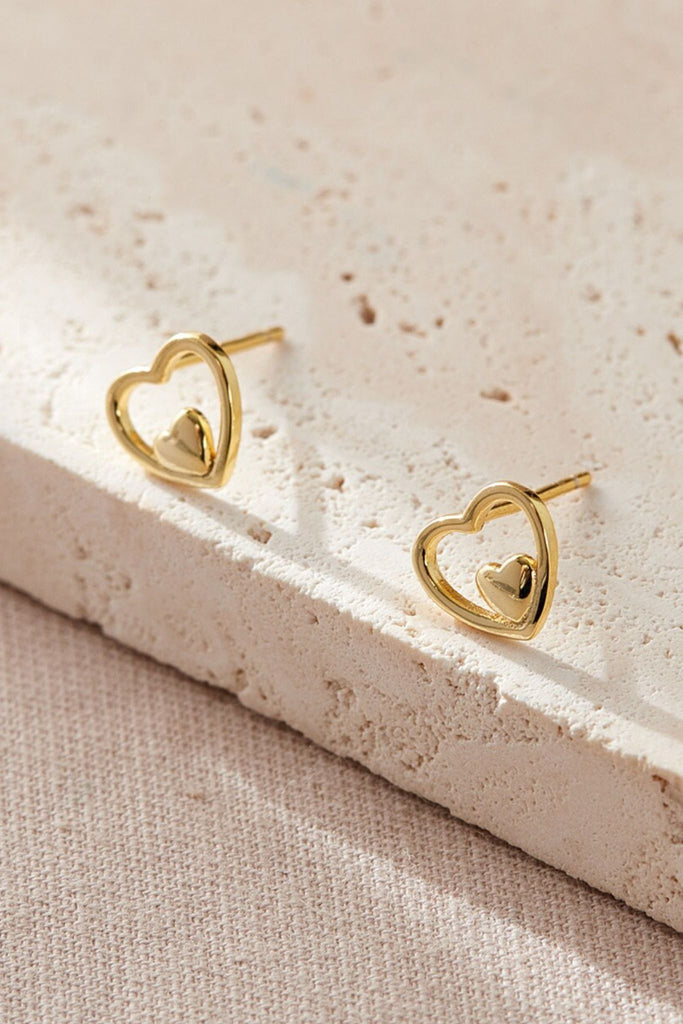 close up of the gold plated sterling silver openwork heart stud earrings