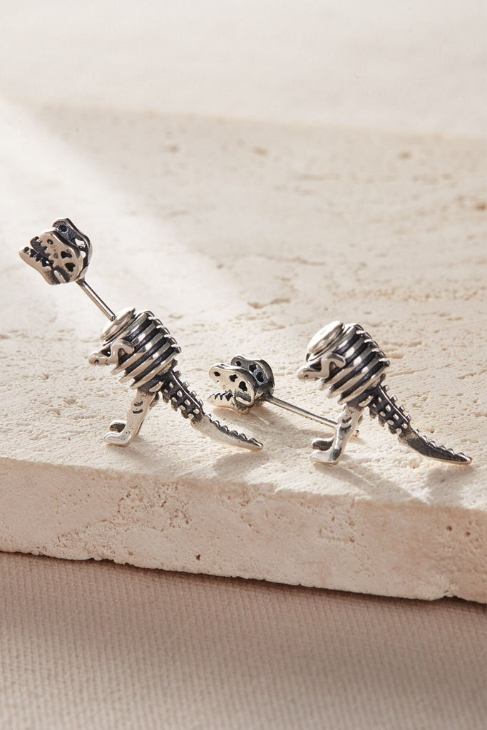 showing the detachable head which fits into the body of the dinosaur, creating an ear jacket earring