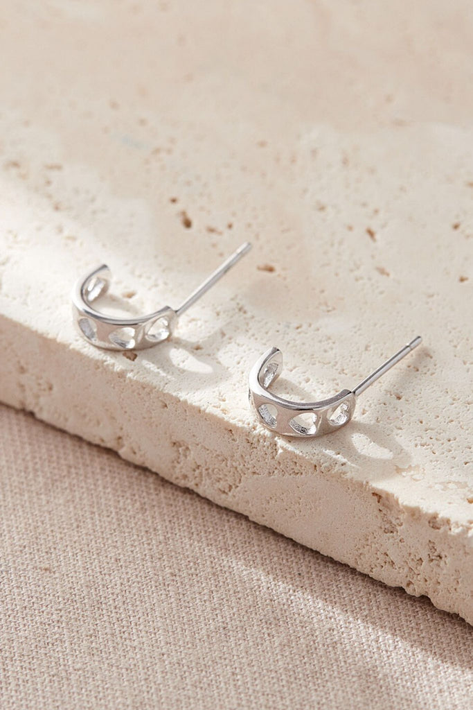 close up of the silver half hoop earrings