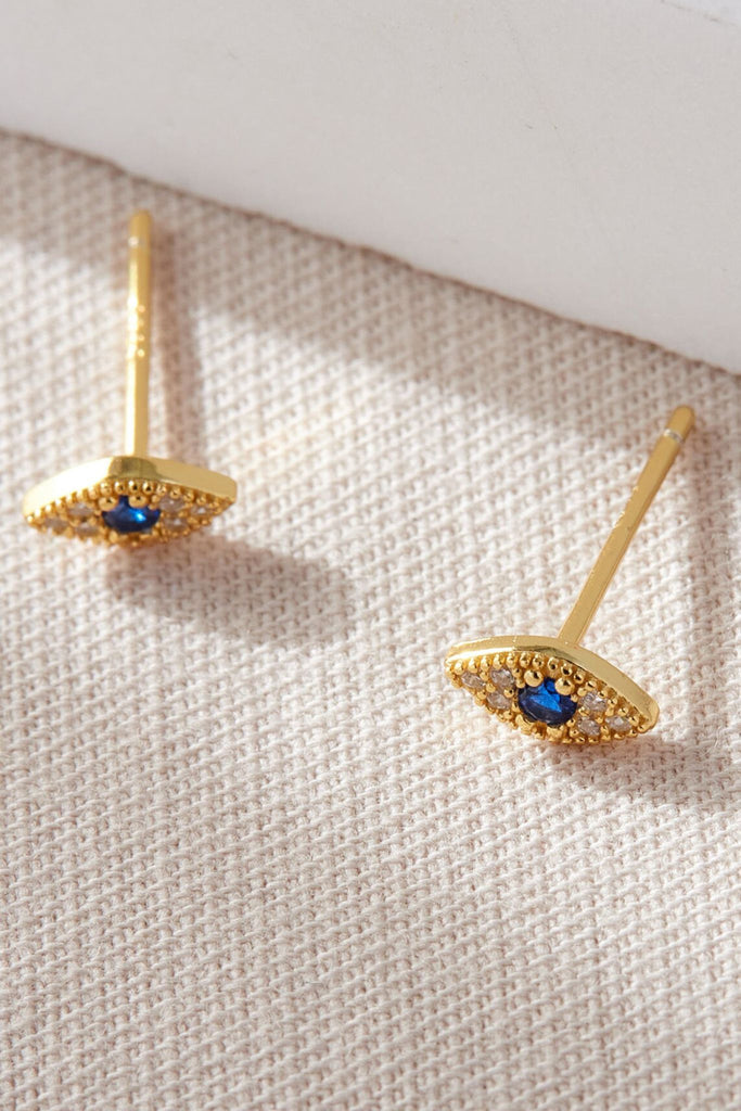 gold plated sterling silver and sparkly cz stud earrings shaped like and eye with a blue centre