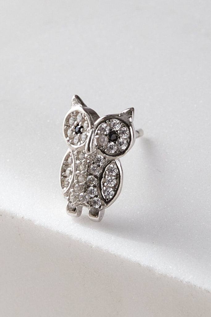 close up of the sparkly owl stud earring, showing the detail of the owls eyes, ears and wings