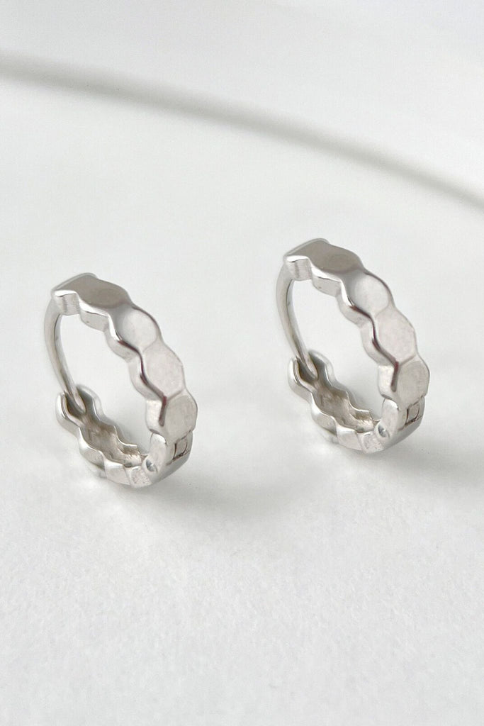 close up of the silver honeycomb huggie hoop earrings