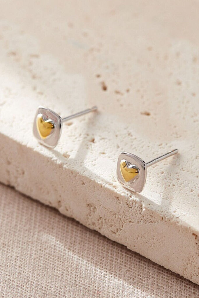 square sterling silver stud earrings with gold plated gold love hearts in the middle, the studs have butterfly backs