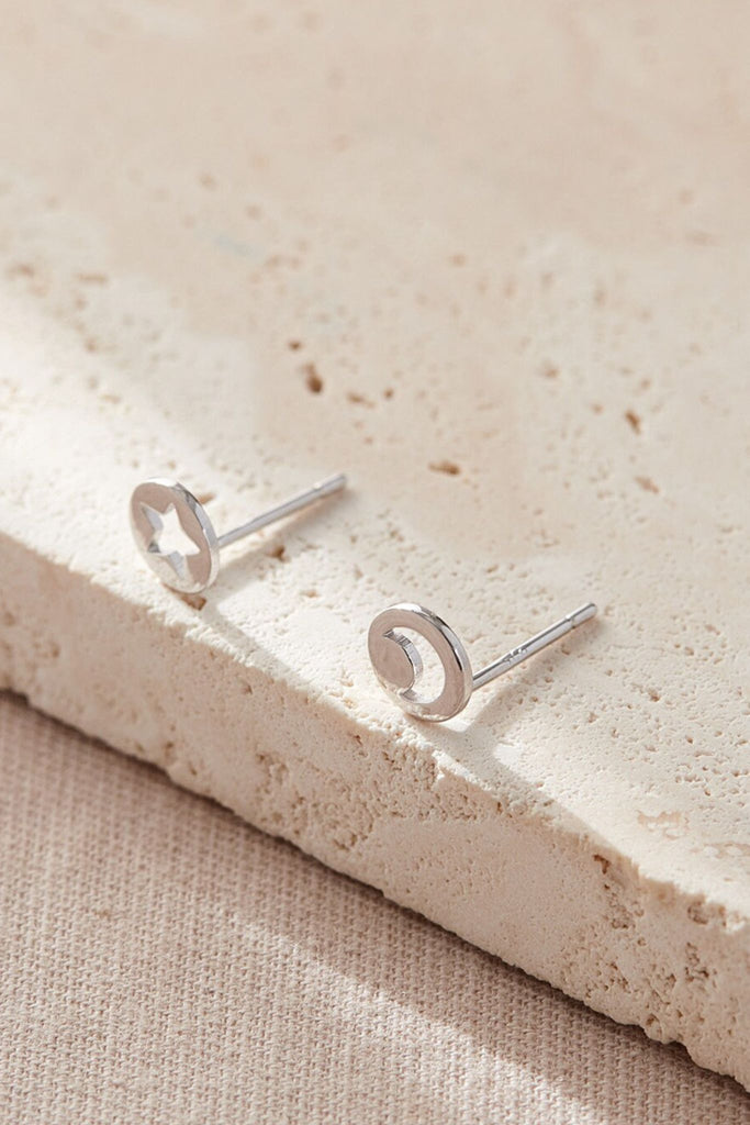 close up of the asymmetrical star and moon stud earrings