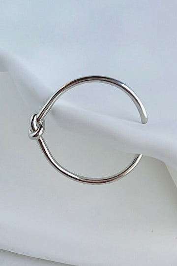 thin open ring made from s925 sterling silver, the ring has a knot design in the middle, symbolising love and unity