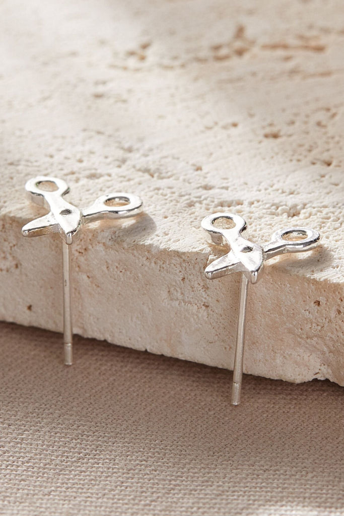 close up of the silver scissor stud earrings
