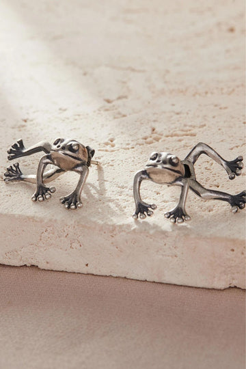 sterling silver frog ear jacket earrings, the earrings separate on each side of the lobe with the frog's head and front legs in front of the ear, the back legs behind the earlobe