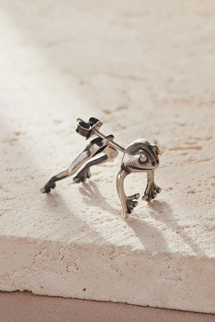 side view of a single frog earring, showing the ear jacket design and butterfly back fastening