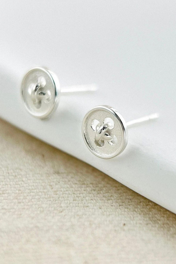 silver stud earrings desgined to look like small round buttons, the earrings have butterfly back fastenings