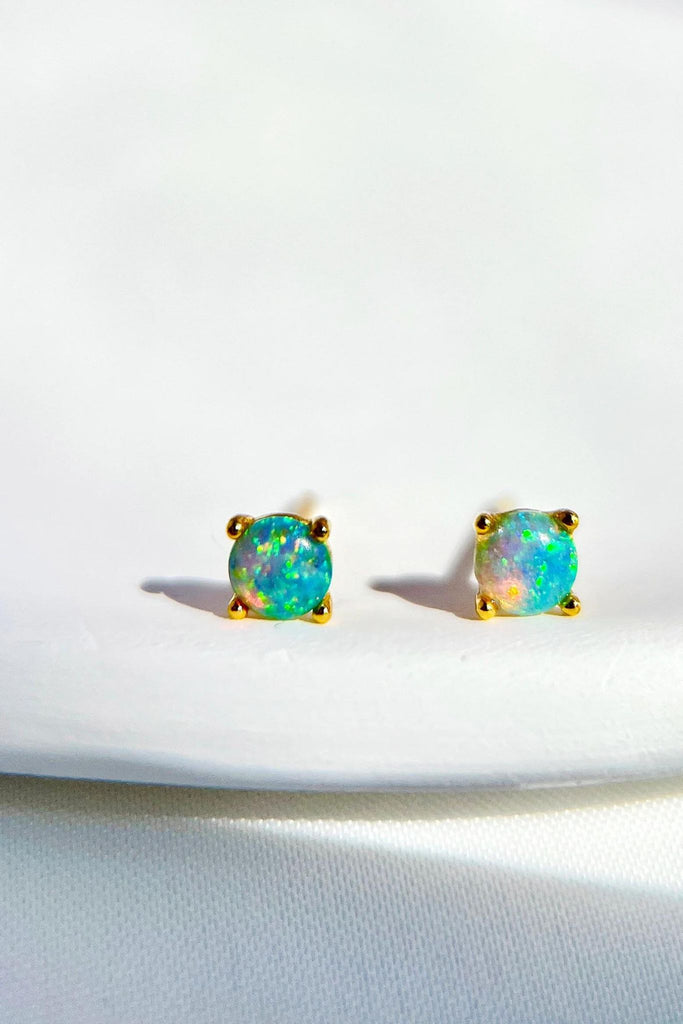 close up of the teal coloured cultured opal studs,