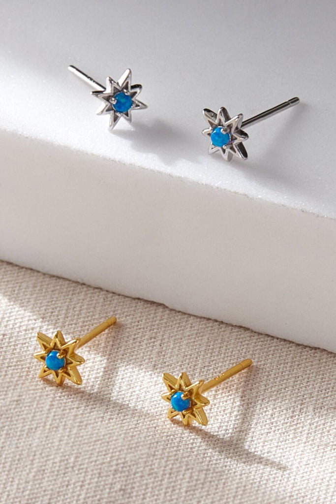 eight point starburst star stud earrings with a small blue lap opal mounted in the middle, these studs are available in silver and gold plated sterling silver