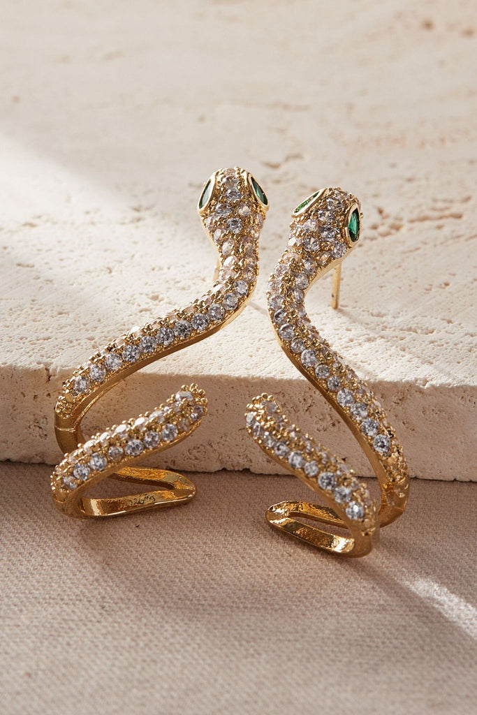 close up of the gold and white sparkly cz snake earrings from above, showing the intricate detail of the sparkly stones