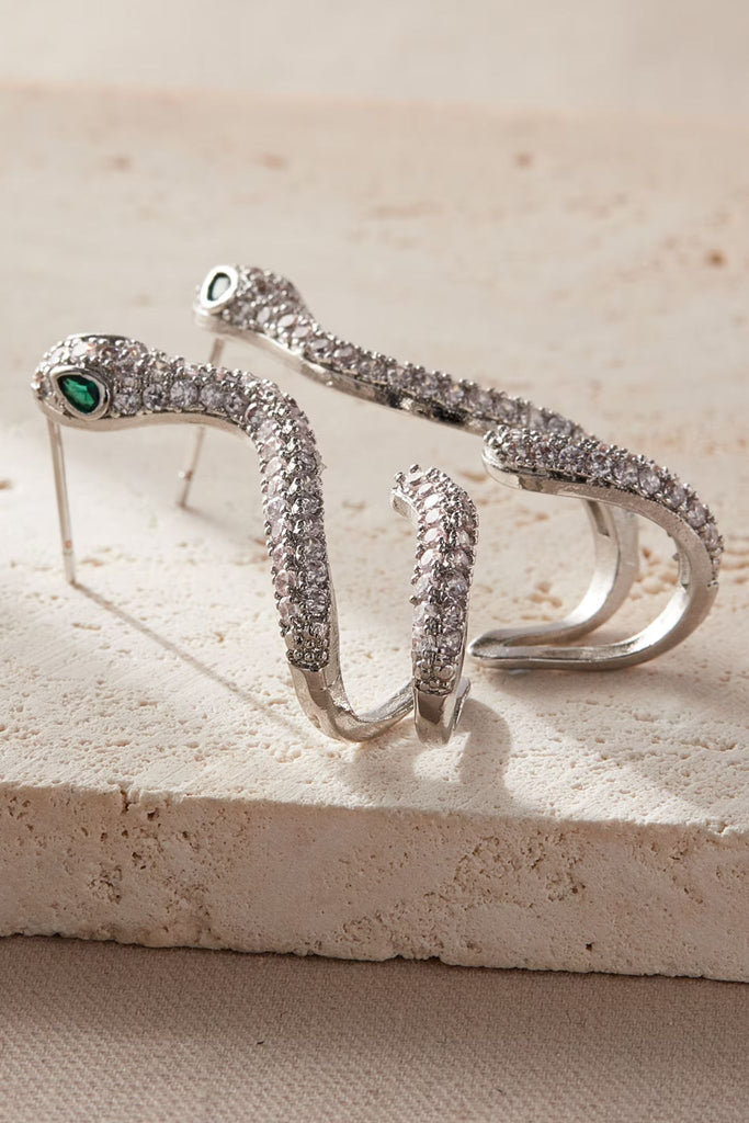 close up of the silver and white sparkly cz snake earrings from above, showing the intricate detail of the sparkly stones