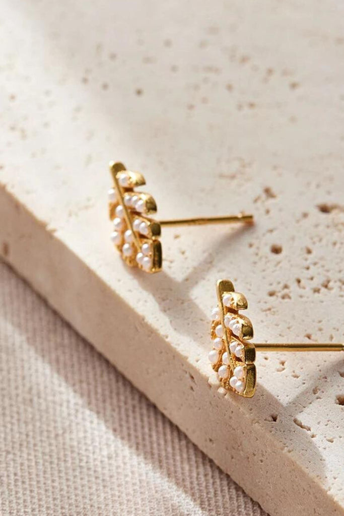 close up of the gold plated silver sparkly leaf stud earrings