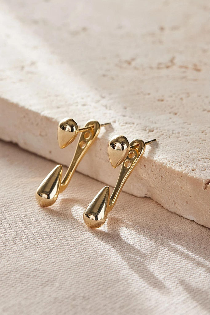 showing the ear jacket earrings up close, they are adjustable in length, the top part can go in one of three holes increasing he length of the waterdrop jacket. 