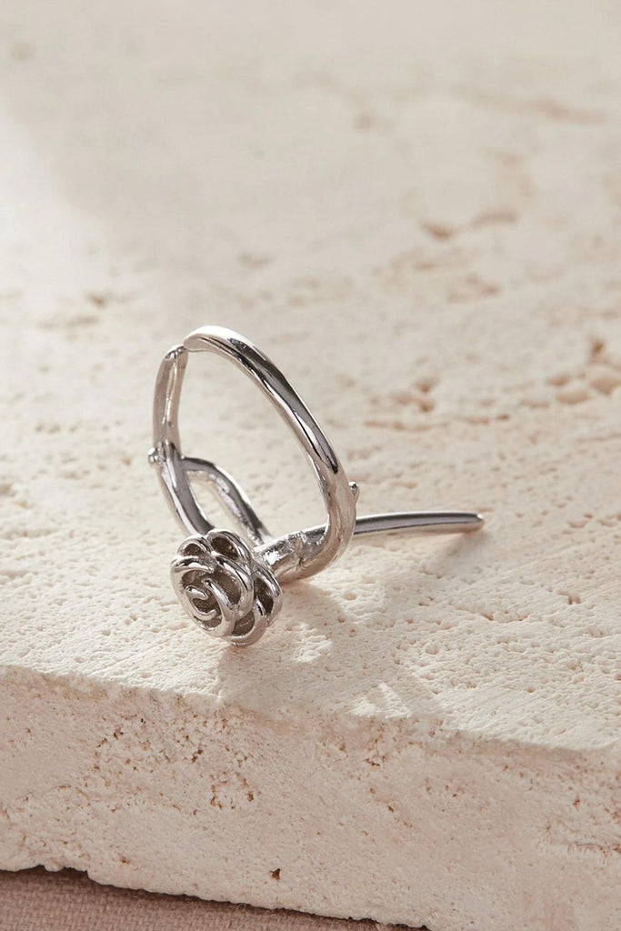 close up of a single sterling silver rose cuff earring