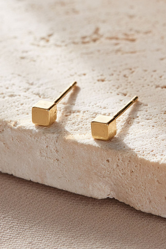 close up of the gold coloured square studs