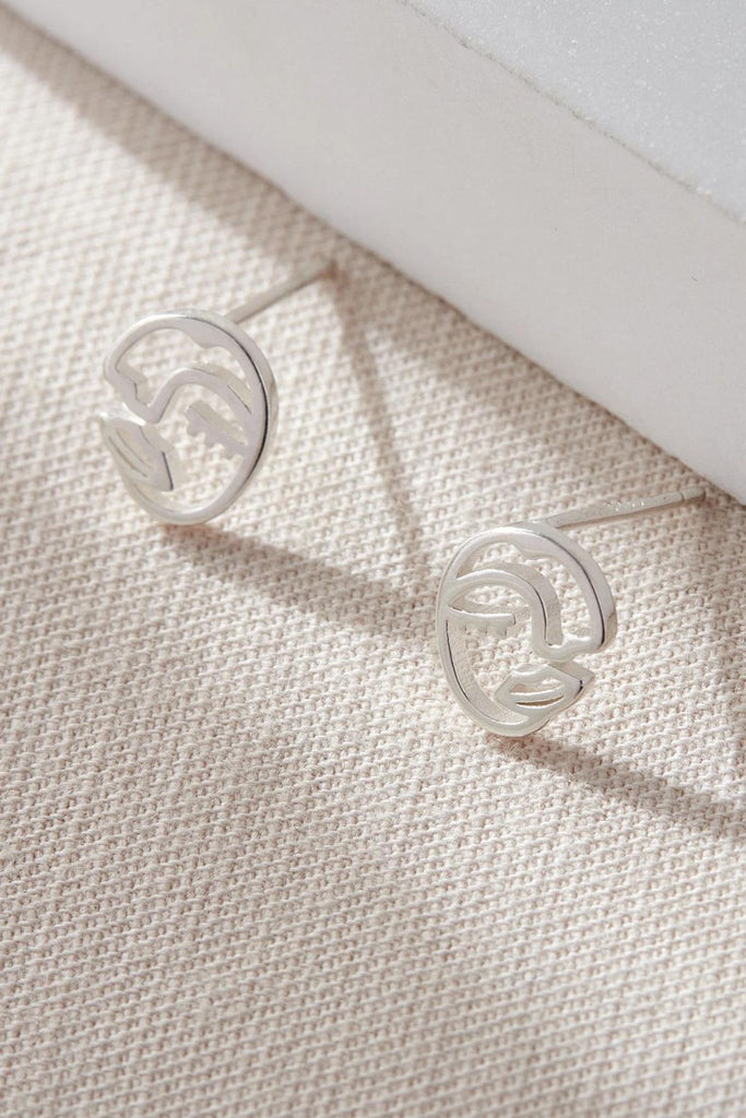 close up of the silver face stud earrings