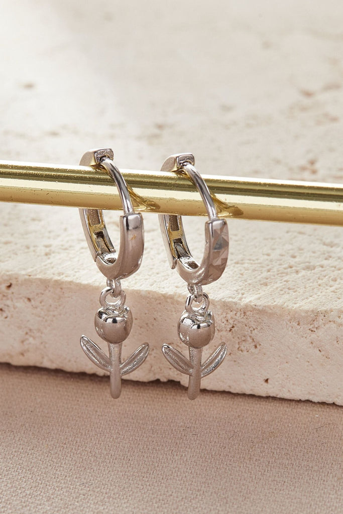 close up of the silver dangle hoop tulip earrings