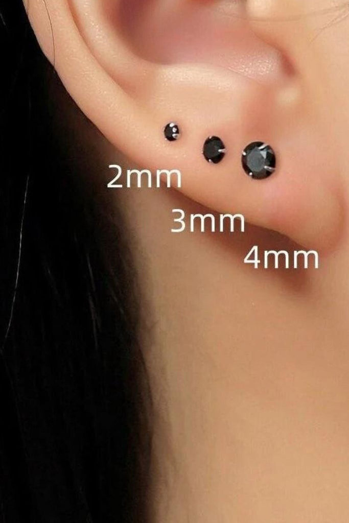 model wearing all three sizes of black cubic zirconia stud earring on the earlobe showing that they can be worn as stacking studs