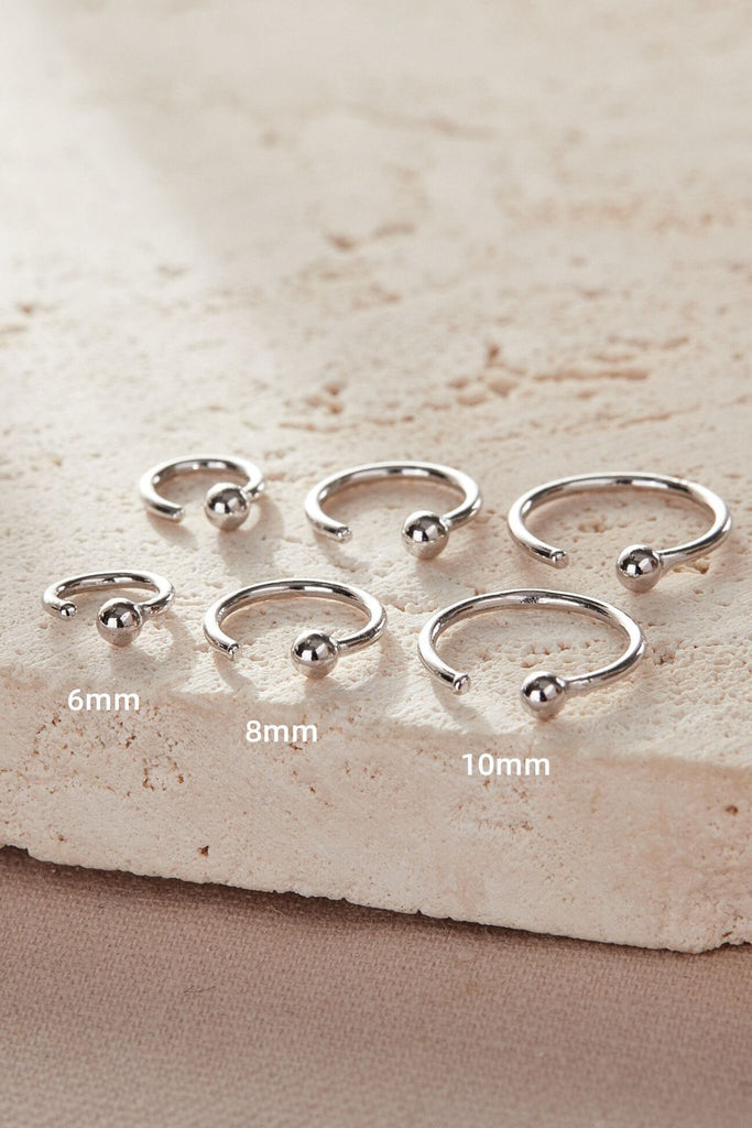 three sizes of ball hook earrings, 6mm, 8mm and 10mm, each earring is worn in the earlobe, hooked through the piercing and held in place naturally by the ball on the end of the hook