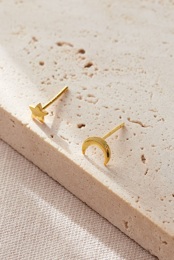 close up of the gold plated sterling silver star and moon stud earrings