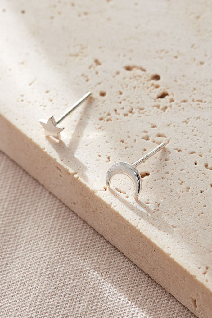 close up of the sterling silver star and moon stud earrings
