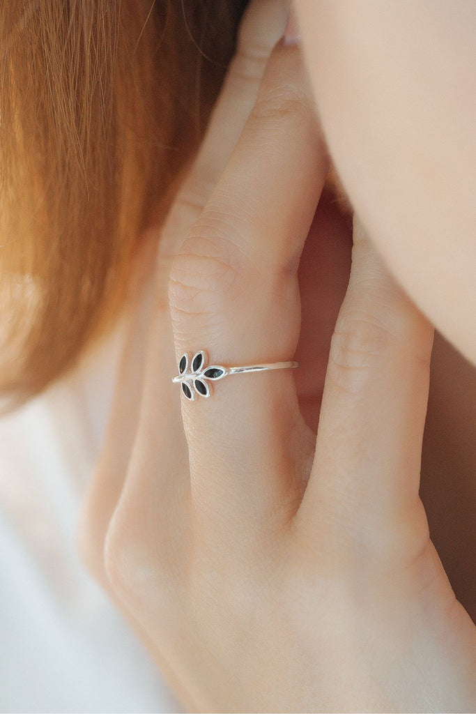 model wearing the black leaf ring on the ring finger, this ring is one size and adjusable