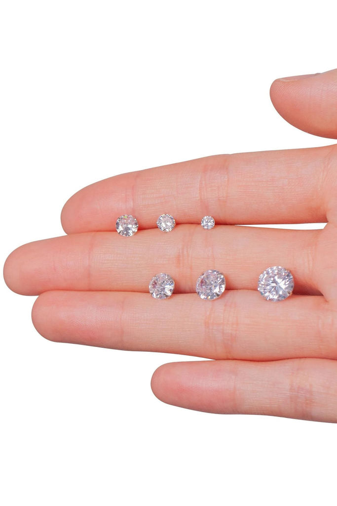 model holding all six sizes of studs in the palm of the hand, showing the size variation between the options