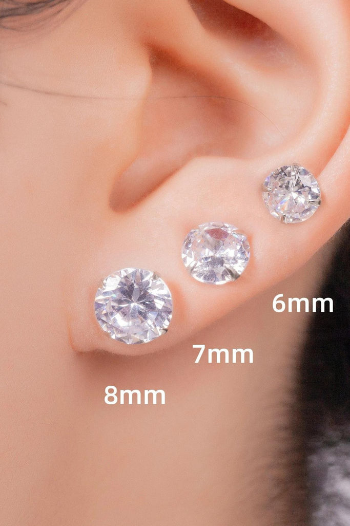 model wearing sizes 6mm, 7mm and 8mm studs in the earlobe showing the size difference between them
