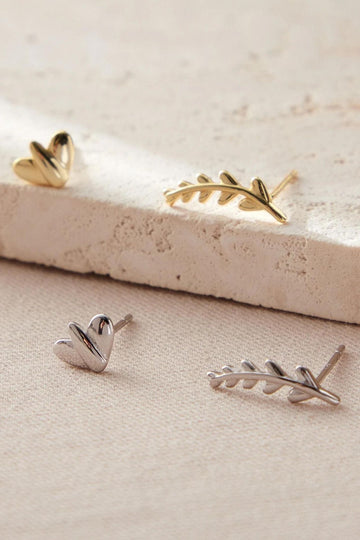 mismatched asymetrical stud earrings, one small leaf and one long branch per pair of earrings, shown in silver and gold plated sterling silver