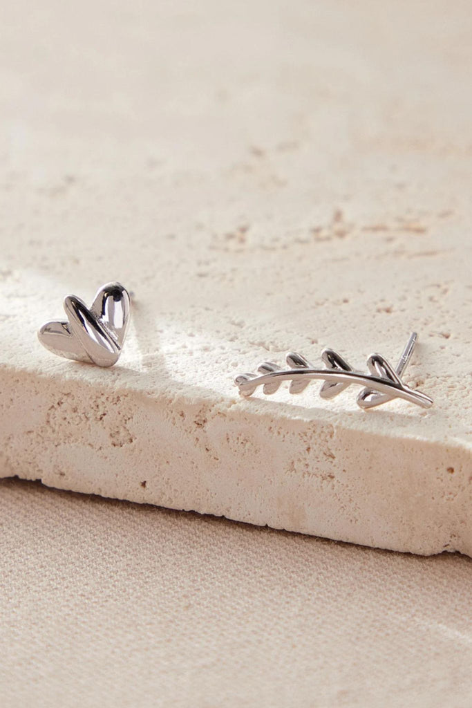 close up of the s925 sterling silver mismatched leaf and branch earrings