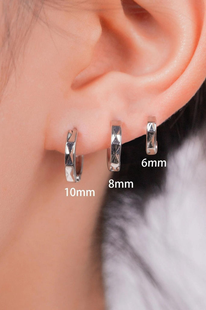 model wearing all three sizes of the silver angular hoop earrings, showing the size difference between them