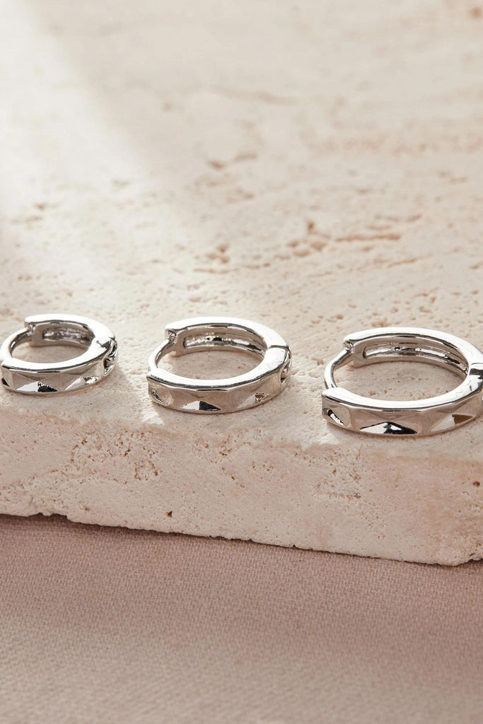 close up of the silver angular hoops