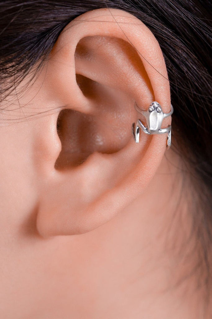 model wearing a sterling silver small frog wrap on ear cuff