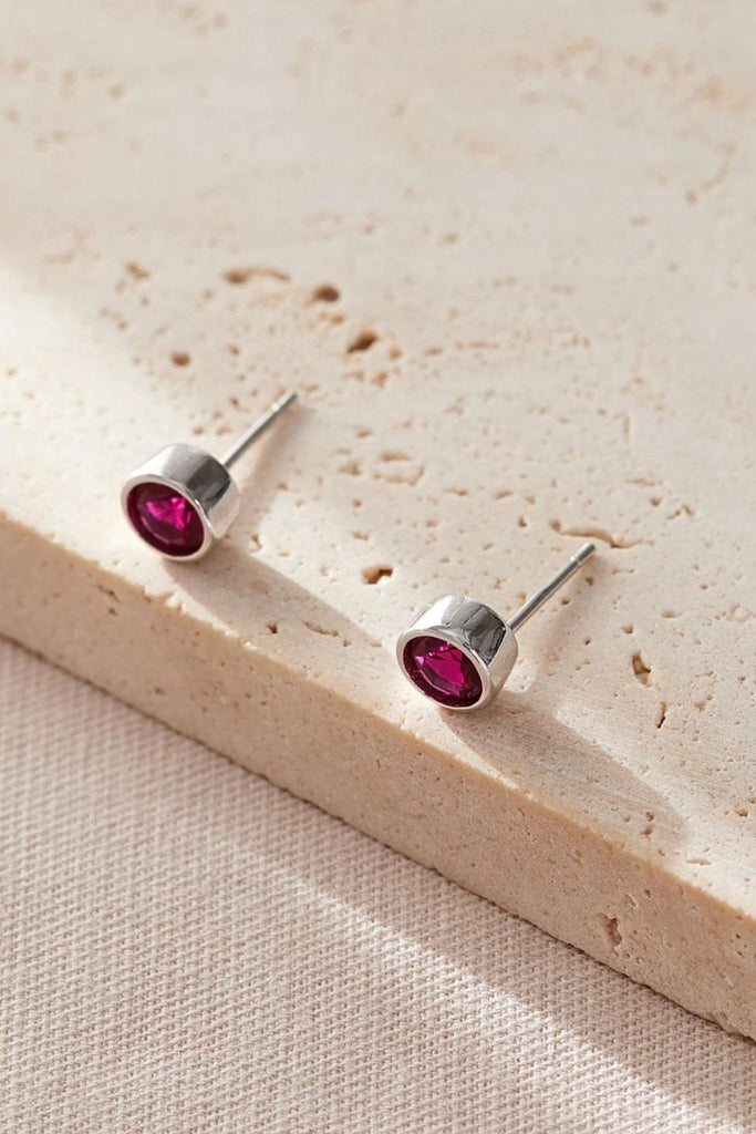 close up of the pink cz round stud earrings, showing the minimalist design of the earrings
