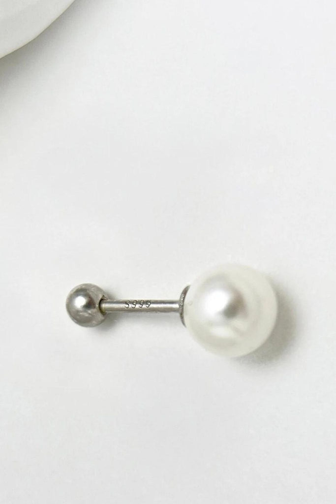 close up of the pearl stud, showing the s999 stamp on the stems and the screw fasting ball back feature of the earrings