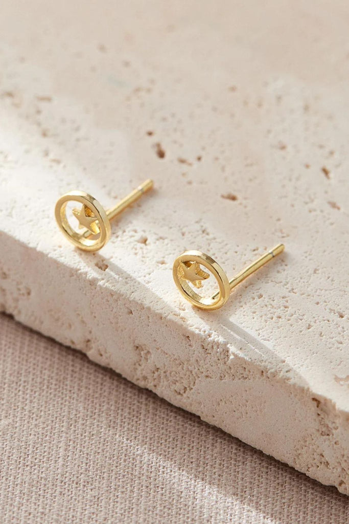 close up of the gold circle and star stud earrings