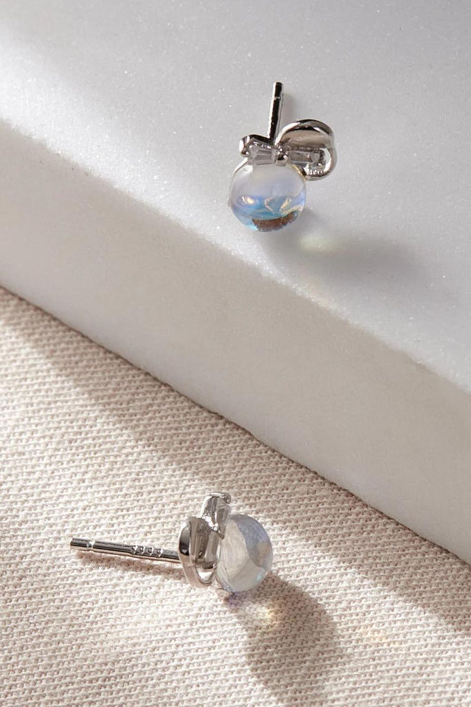 close up of the moonstone earrings, showing the s925 sterling silver stamp on the stems of the earrings 